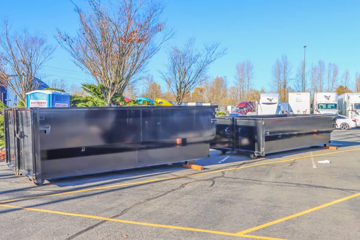 Professional dumpster rental service with roll-off container on residential driveway in Porters Neck